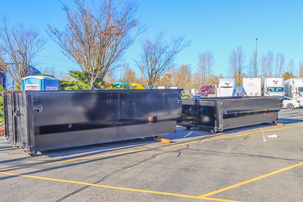 Professional dumpster rental service with roll-off container on residential driveway in Mapleton